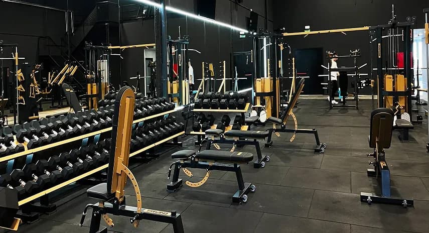 Gotten Gym interior with black equipment and gold details