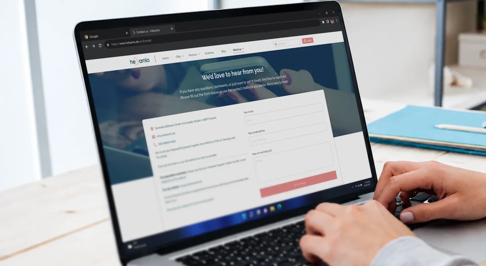 Hebamio's desktop landing page showing the contact form